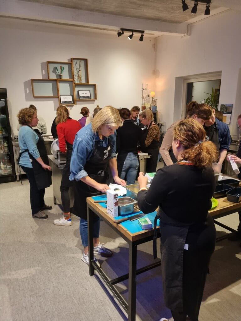 People standing in a room, seemingly preparing food.
