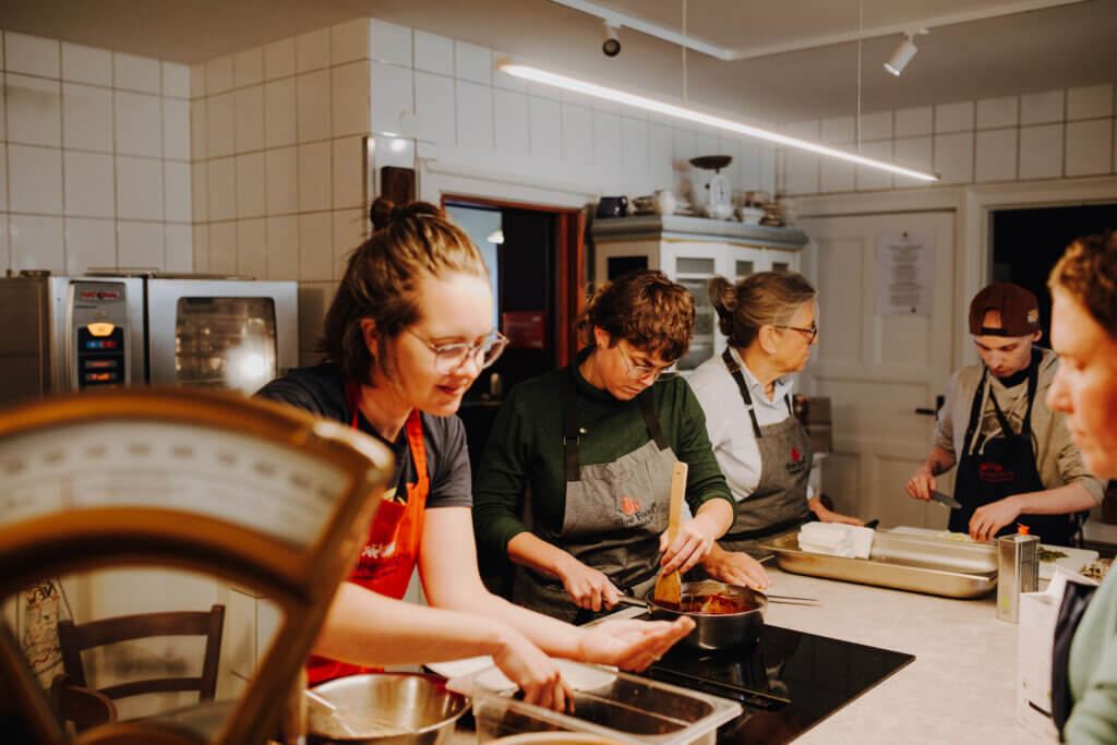 People preparing food on a kitchen counter